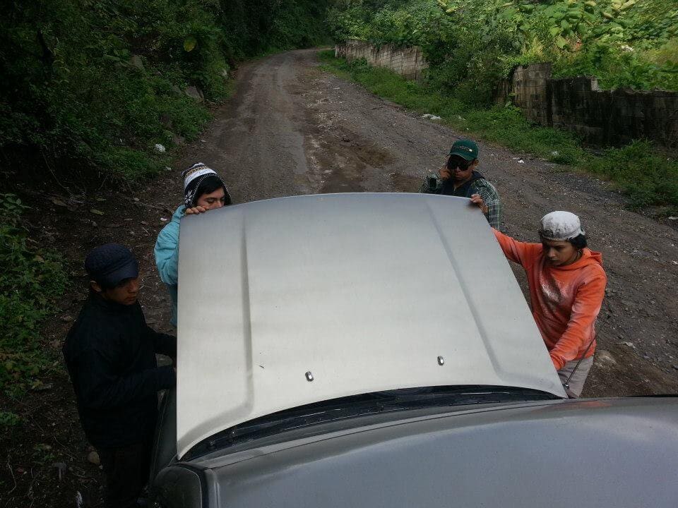 Trying to fix a truck on a dirt road in Guatemala