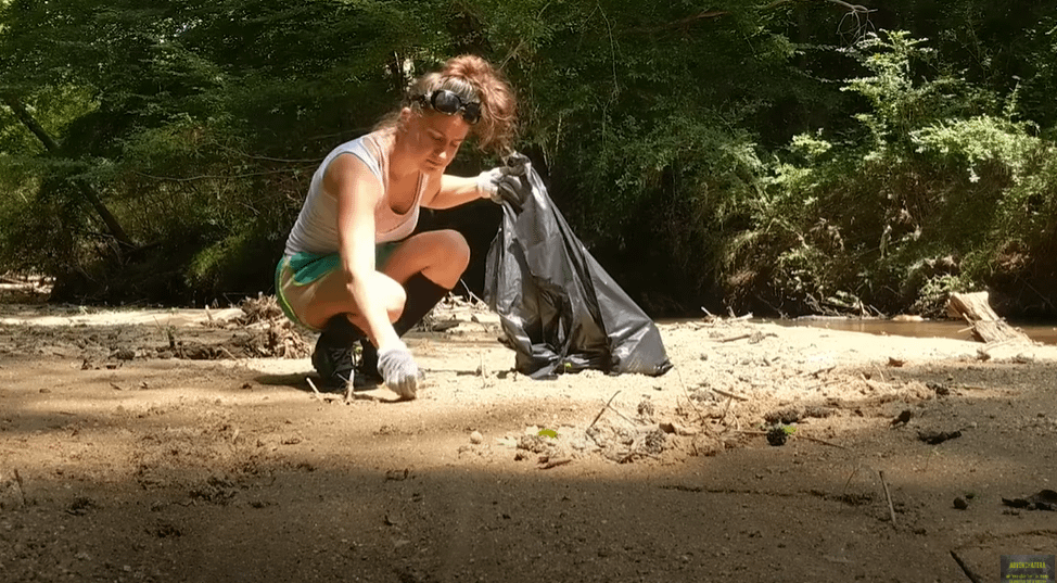 practicing Leave No Trace by picking up trash from a local park