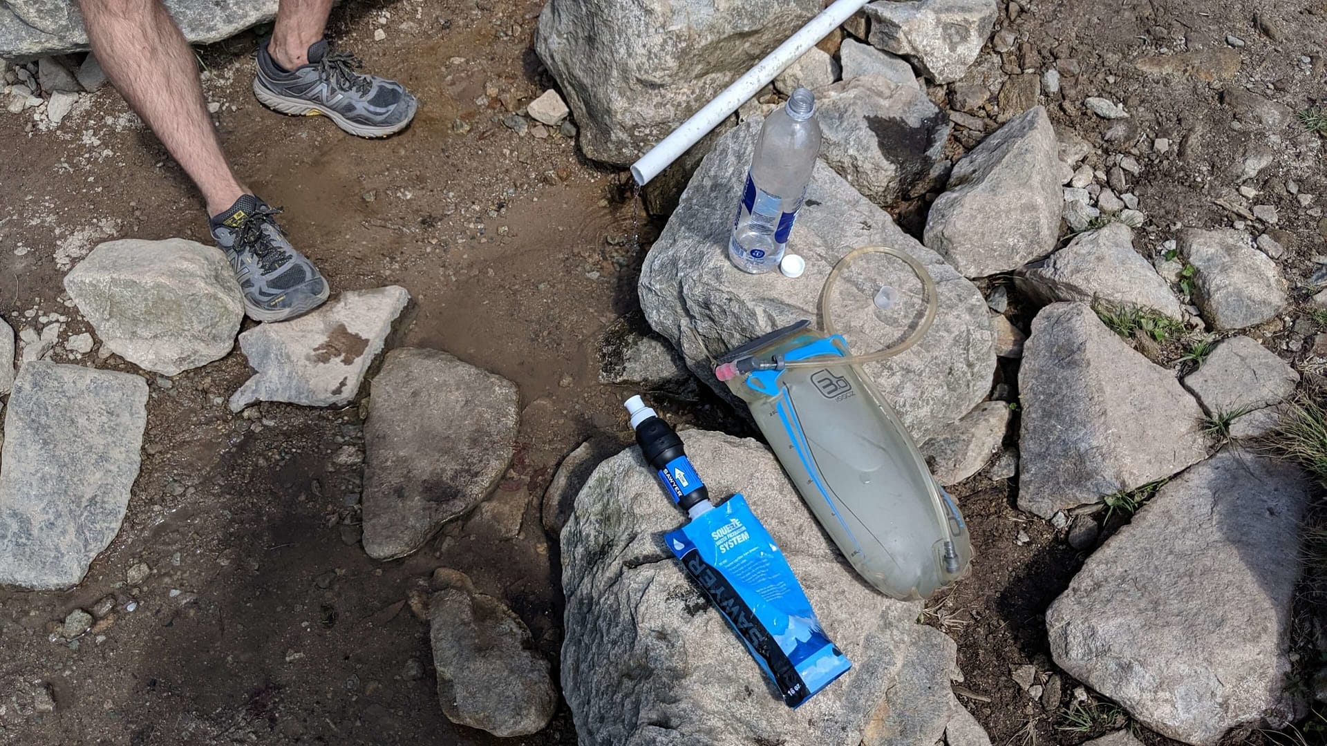 How Much Water to Take Hiking? Lots of water. Pictured here is a hydration reservoir and sawyer squeeze filter