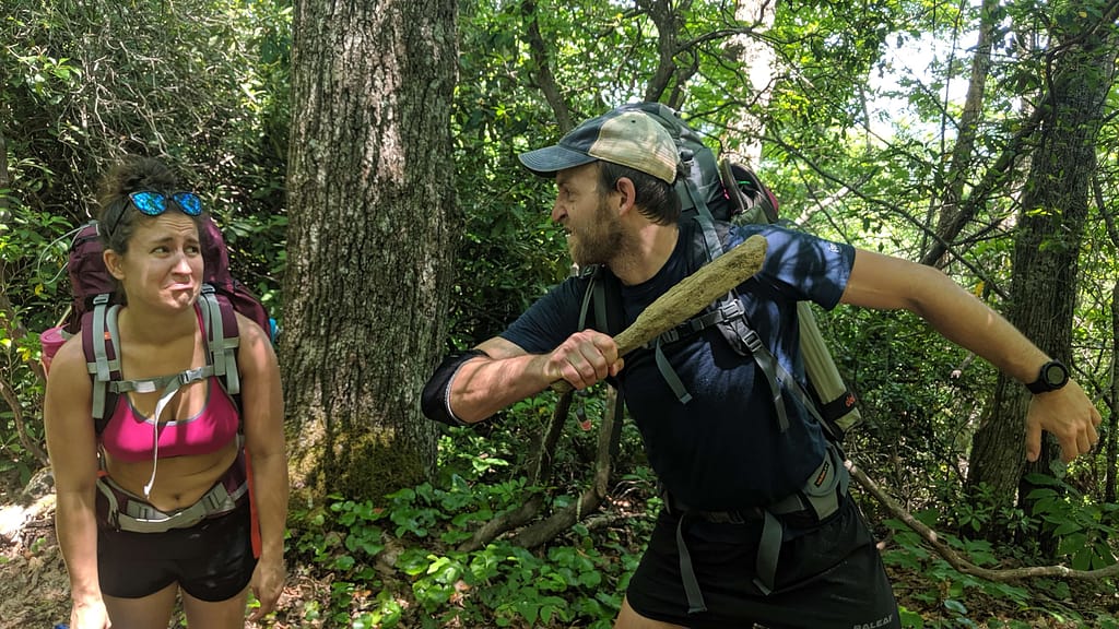 Guy beating woman on a hiking trail joke photo
