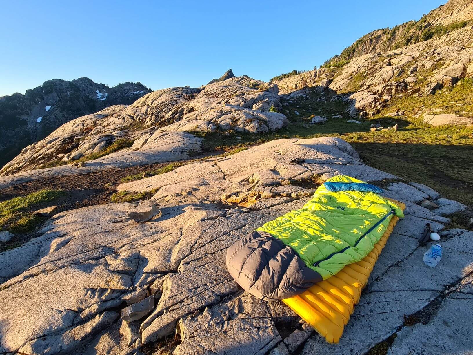 Backpacking Gear on a rock, sleeping bag and pad