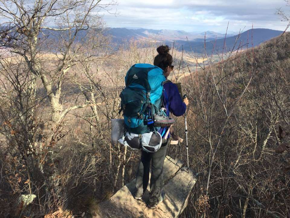 girl with backpacking gear overlooking virginia close to mcafee knob