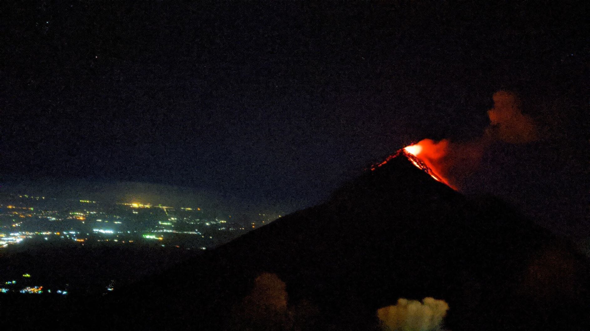 Fuego spewing lava view from acatenango volcano at night